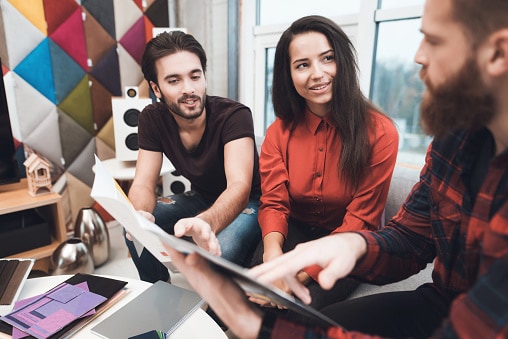 Business colleagues in a collaborative space talking about a project.